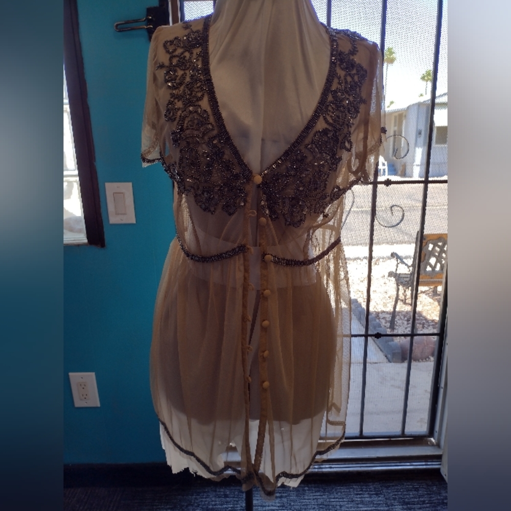 Woman's sheer beaded button front top